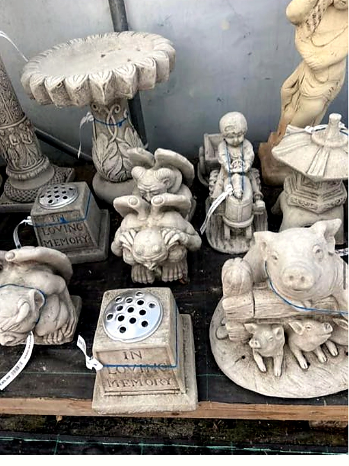 Stone gargoyle, pig and memorial ornaments on the ornament display