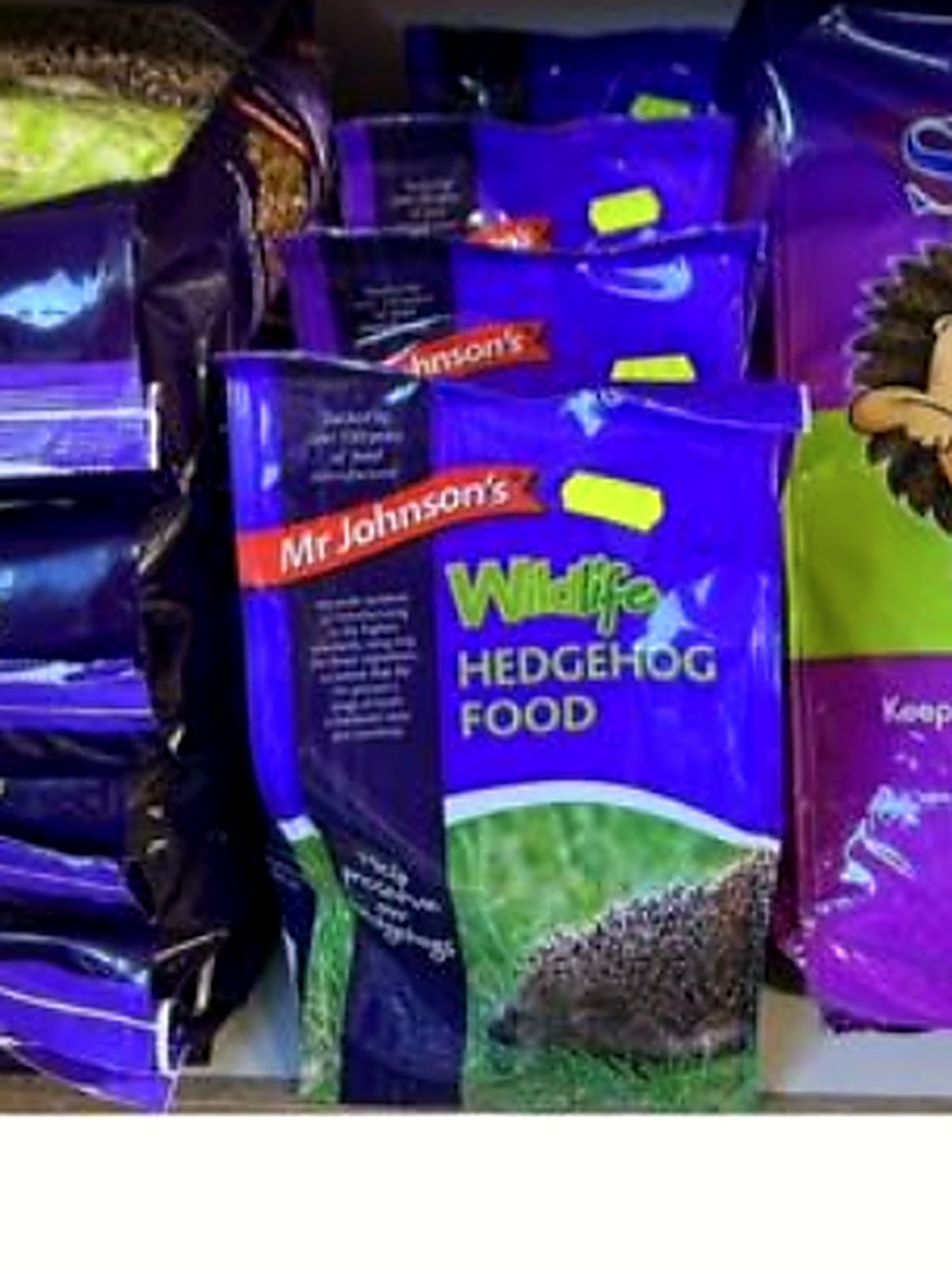 Bags of Mr Johnson's and Spike's hedgehog food on the feed shelves